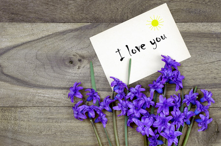Bouquet of spring flowers on a wooden table. copy spaces. I love mom. Mothers Day.の写真素材