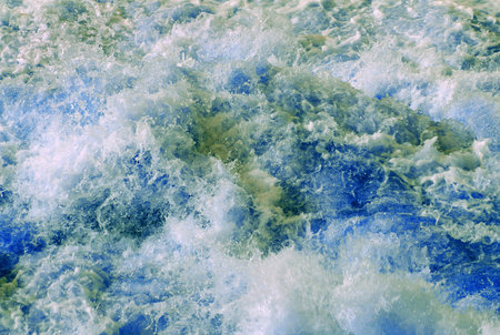 Rapid flow of water. Flowing water abstract background. Splashes and waves on the water