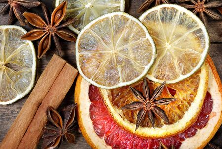 Christmas background of dried fruits and spices. dried grapefruit, orange, lime, anise stars and cinnamon sticks texture backgroundの写真素材