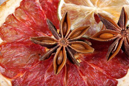 Christmas background of dried fruits and spices. dried grapefruit, lime and anise stars texture backgroundの写真素材