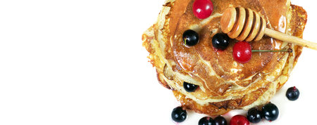 pancakes with honey and berries on a white. copy spaces