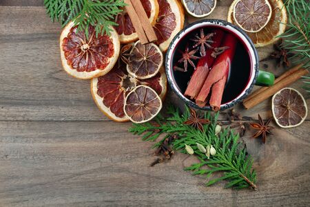 Christmas background. mulled wine in a vintage green mug. mulled wine with traditional spices and dried citruses. cold and flu remedy.の写真素材