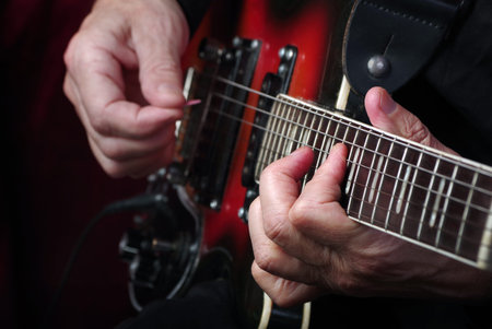 Guitarist hands and guitar close up. playing electric guitar.