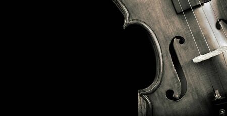 Fragment of a violin on a black background. Concert poster for classical music. Music concept. black and white.の写真素材