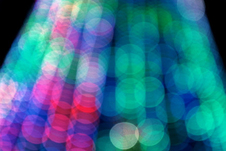 Abstract blurred background. Blurry lights. Blurry garland with multicolored lights. Multicolored...