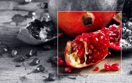 juicy ripe pomegranates on a wooden table. bright colorful pomegranate fruits.の写真素材