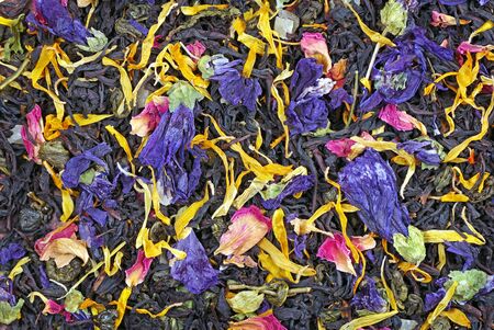 black blended tea with flower petals and slices of dried fruit texture backgroundの写真素材