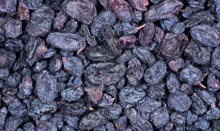 Black raisins texture background. sweet dried fruit. blue grape raisinsの写真素材