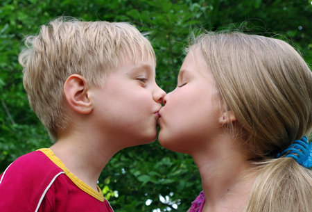 Love concept. little boy kissing girl. innocent baby kiss. first kiss. boy and girlの写真素材