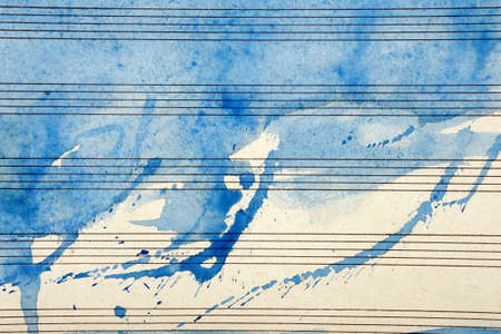 Old music sheet in blue watercolor paint. Blues music concept. Abstract blue watercolor background. copy spaceの写真素材