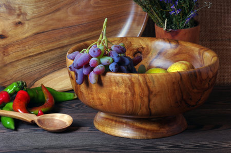 Handmade wooden utensils on the kitchen table. Wooden plates, bowls, dishes and spoons on the tableの写真素材