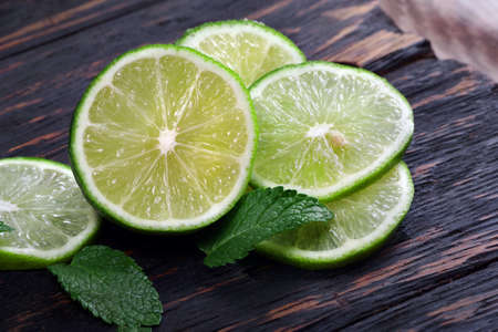 lime and mint on a wooden table. traditional ingredients for winter vitamin teaの写真素材