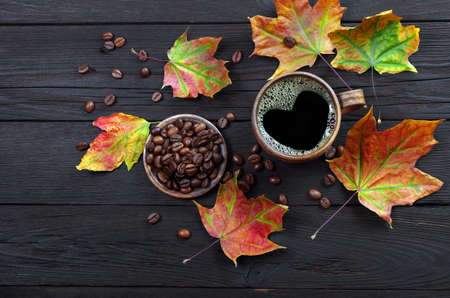 autumn coffee. dry colorful maple leaves and a cup of coffee. autumn moodの写真素材