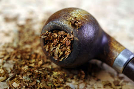 Smoking pipe and tobacco on wooden table. close upの写真素材