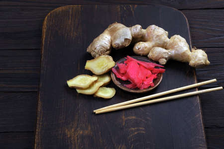 pickled pink ginger and fresh root on the table. traditional sushi seasoningの写真素材