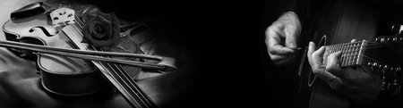 Playing an Acoustic Guitar and Violin black and white. Guitarist hands and guitar, violin and rose close up.の写真素材