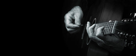 Guitarist hands and guitar close up. playing electric guitar. copy spaces. black and white.
