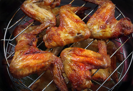 ruddy chicken wings on the grill. close up. copy space