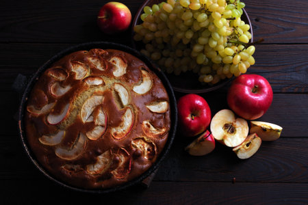 apple pie and fruits on a wooden table. top viewの写真素材