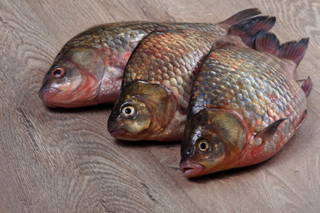 Fresh fish on the kitchen table. fish crucian carp on the table close-up