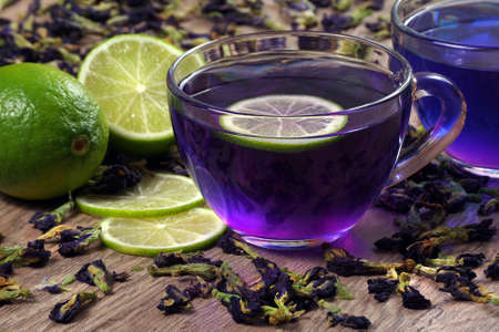 anchan drink on a wooden table. cup of Butterfly pea tea and lime.の写真素材