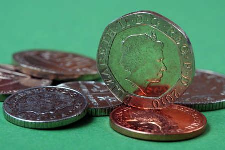 coins of Great Britain on a green background close-up. British coins close-up.の写真素材