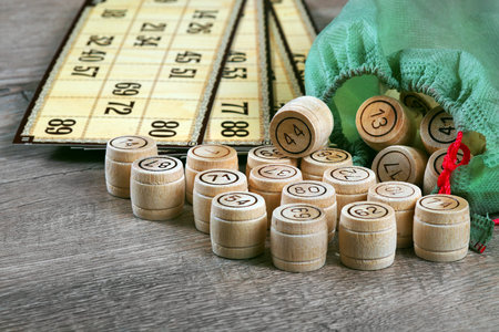 Lotto game. Wooden lotto barrels and card on a wooden table.