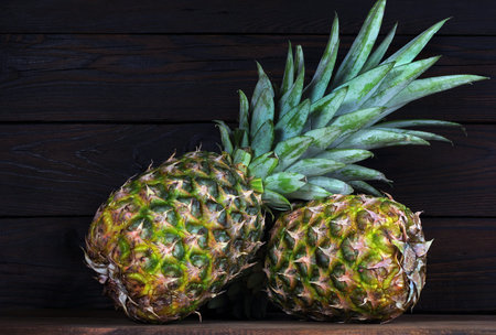 ripe pineapples on a wooden table