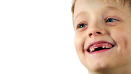 child with missing teeth. toothless smiling boy. copy space
