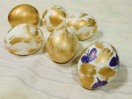 Easter eggs painted in gold and blue colors on a white background