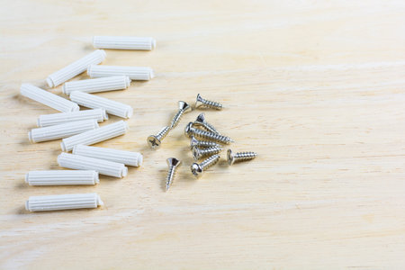 Screw and Anchor bolt plastic on wood table.の写真素材