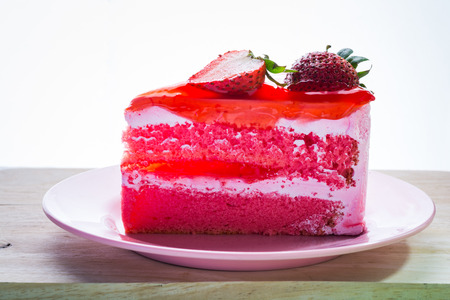 Pink strawberry cake delicious with green mint on pink dishの写真素材