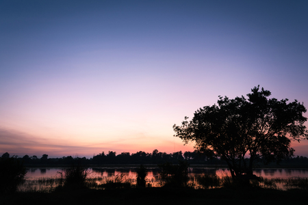 Sunrise landscape with a lake and the mist over the riverの写真素材