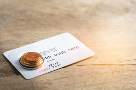 White credit cards and coins on wood background. Financial conceptの写真素材