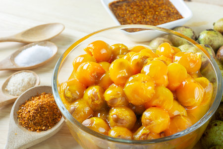 Ceylon oak in glass bowl peel reveal appetizing orange fruit on wood table. thai fruit.