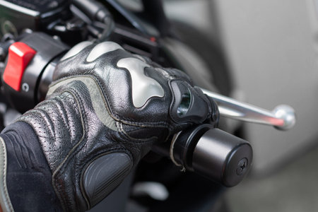 Close up of throttle control hand and brake lever motorcycle, Hands wearing black leather gloves...