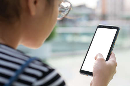 Women hand holding smartphone with wite blank screen. Communication social media technology modern lifestyle concept.の写真素材