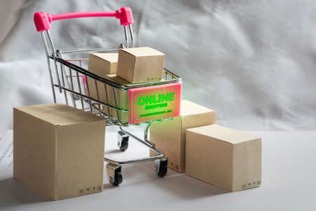 Paper shopping small box express in a shopping carton wood table background. Online shopping concept.の写真素材