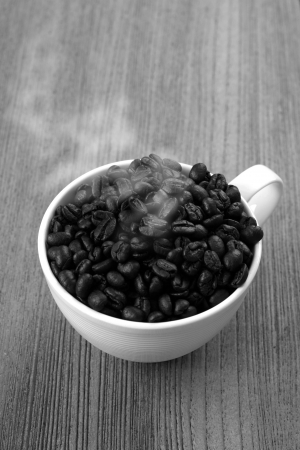 Black and white coffee cup on a wooden floor.の写真素材