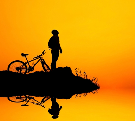 Man and bike silhouette with the sky as background.の写真素材