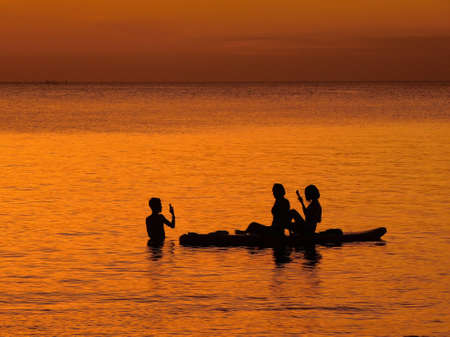 tourist swimming and take a photo in Thailand Sunset beachの写真素材