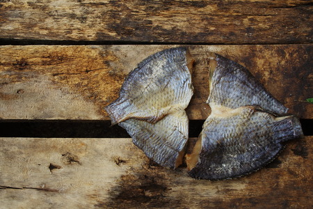 Two Salted Fish on the Old Wood の写真素材