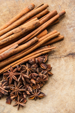 Cinnamon Sticks and Anise Stars on the Old Woodの写真素材