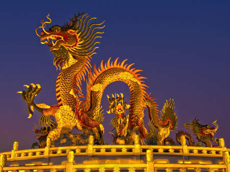 Gold dragon on twilight skyの写真素材