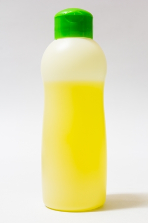 Yellow liquid in plastic bottle on white backgroundの写真素材