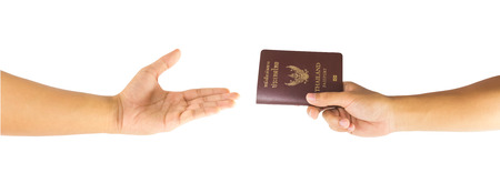 Thailand passport in hand and open hand isolated on white backgroundの写真素材