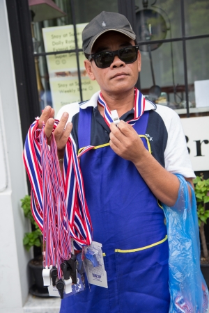 BANGKOK - NOVEMBER 8, 2013 : The whistle salesman in Anti-government protesters to the Democracy Monument on November 8, 2013 in Bangkok, Thailand. The protest Against The Amnesty bill in Bangkok, capital of Thailandのeditorial素材