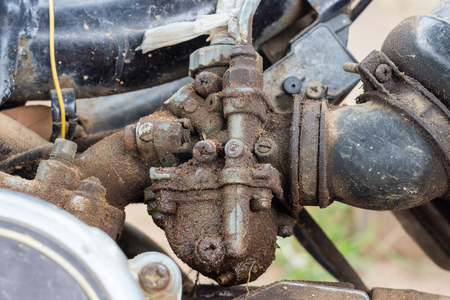 Old Shabby carburator sticked by olid slick  in old motorcycleの写真素材