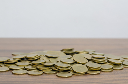 Thai baht money golden coins above wooden tableの写真素材