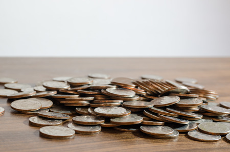 Thai baht money coins pile above wooden tableの写真素材